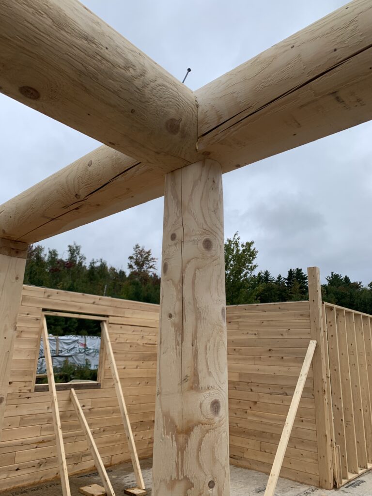 Interior of custom Northern White Cedar log home with timber framing