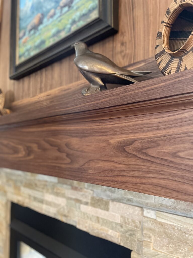 Custom fireplace surround in Boise Idaho with hardwood mantel and detailed finish carpentry