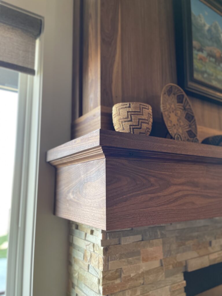 Custom fireplace surround in Boise Idaho with hardwood mantel and detailed finish carpentry